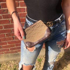 Coach wristlet with brown tones signature canvas.